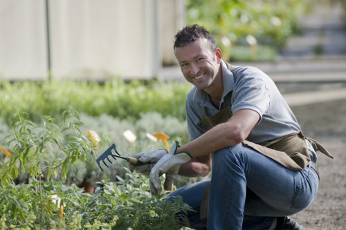 Photo of a gardener adjusting a raised bed to improve physical access